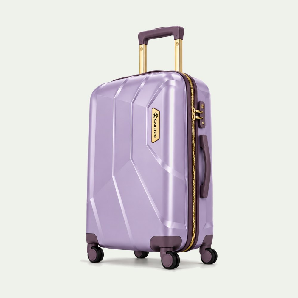 Carlton faceted hard shell suitcase in light purple with plum trim and gold hardware, four wheels